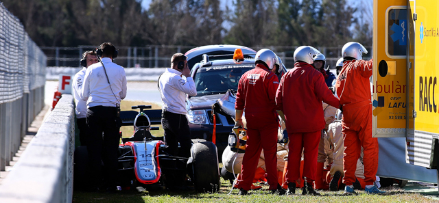 MONTMELO, SPAIN - FEBRUARY 22: Fernando Alonso of Spain and McLaren Honda receives medical assistance after crashing during day four of Formula One Winter Testing at Circuit de Catalunya on February 22, 2015 in Montmelo, Spain. (Photo by Mark Thompson/Getty Images)