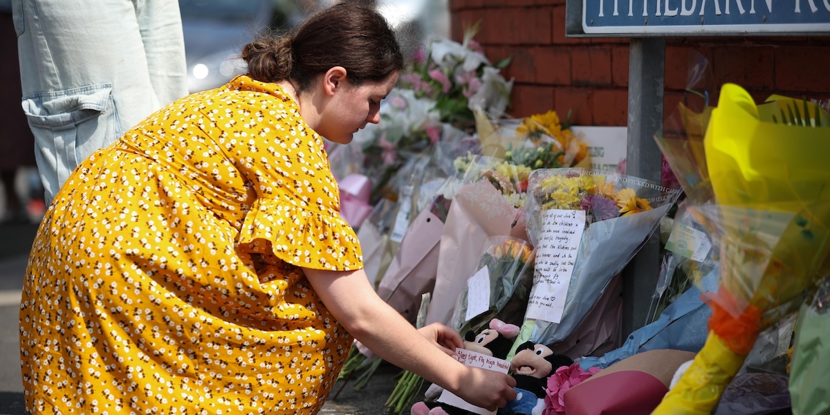 Una donna lascia un biglietto sul luogo dell'accoltellamento di lunedì a Southport, in Inghilterra