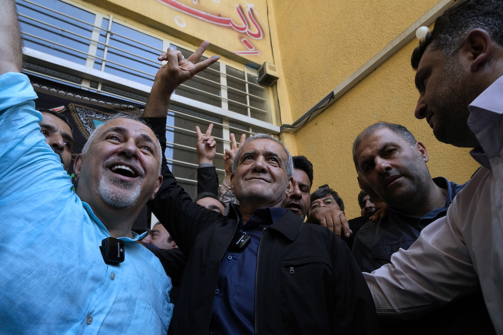 Pezeshkian, center, on voting day in Iran, with former Foreign Minister Javad Zarif (left) 