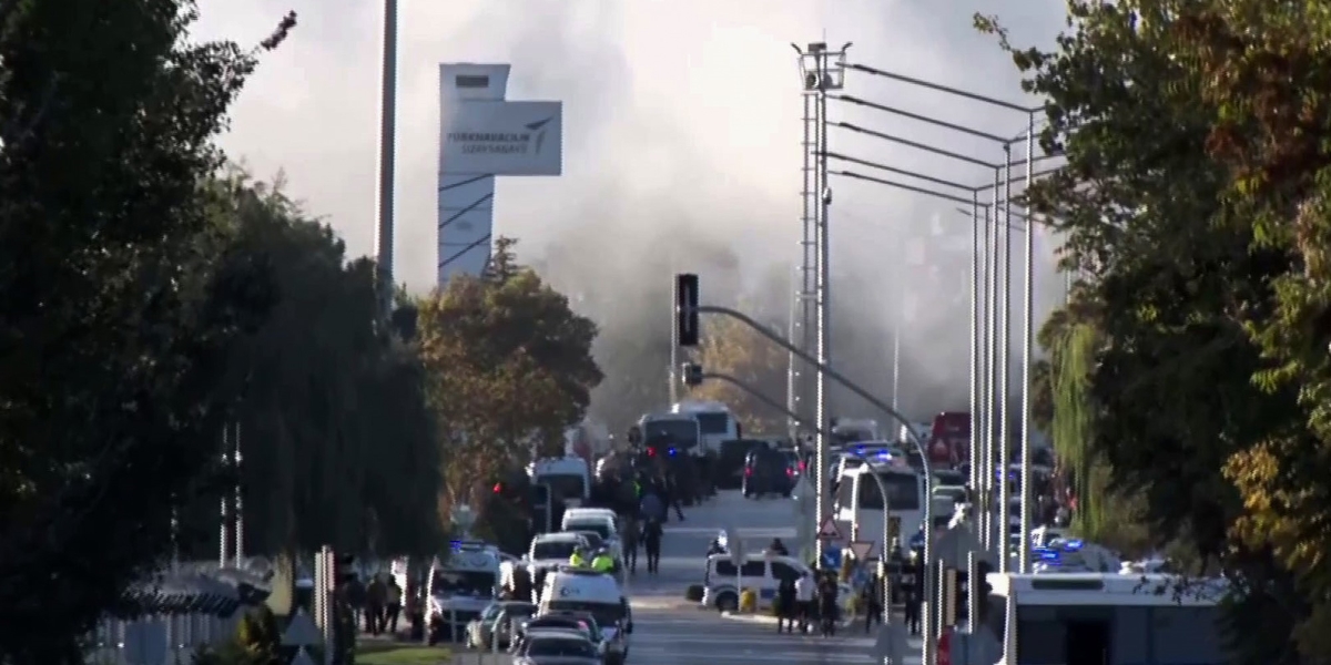 Agenti di polizia, mezzi di emergenza e fumo fuori dalla sede della Società aerospaziale turca, il 23 ottobre 2024 (IHA via AP)